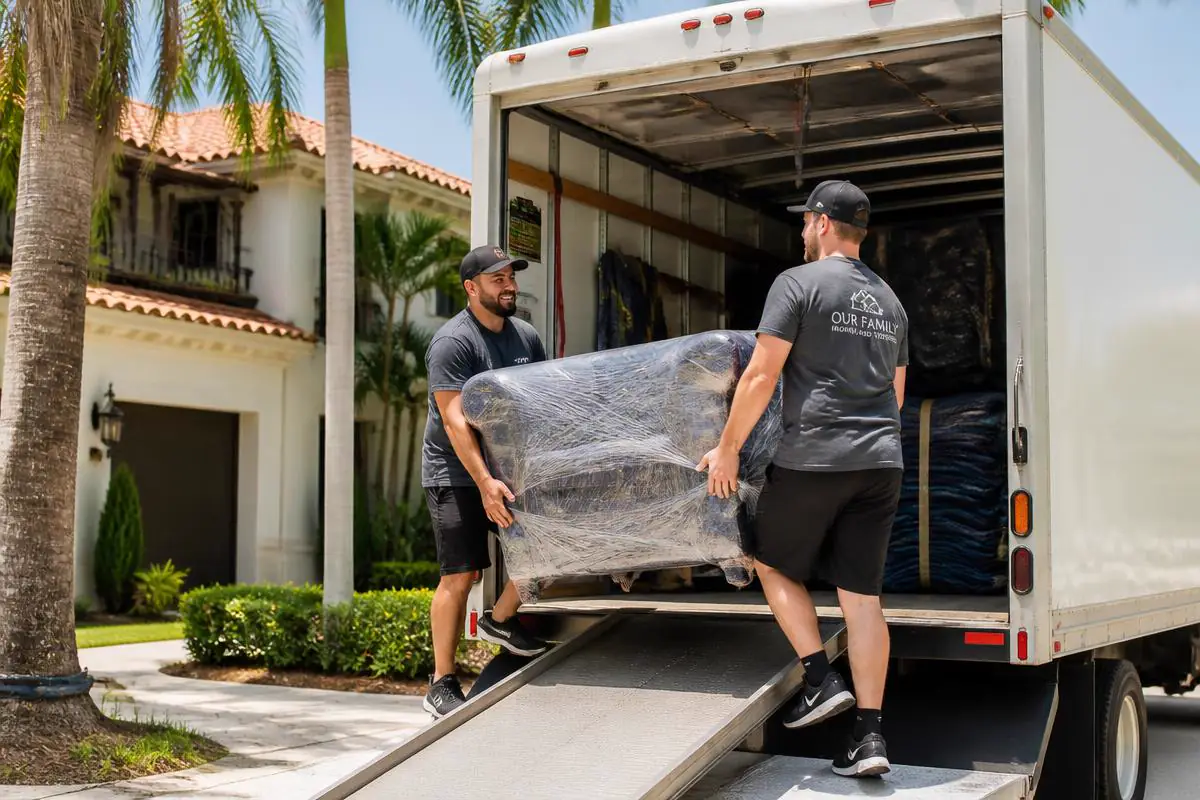 Miles Above Moving crew loading wrapped furniture into a moving truck in South Florida